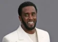 Diddy smiling in a tan suit before his Diddy Manhattan hotel arrest amid a high-profile federal investigation.