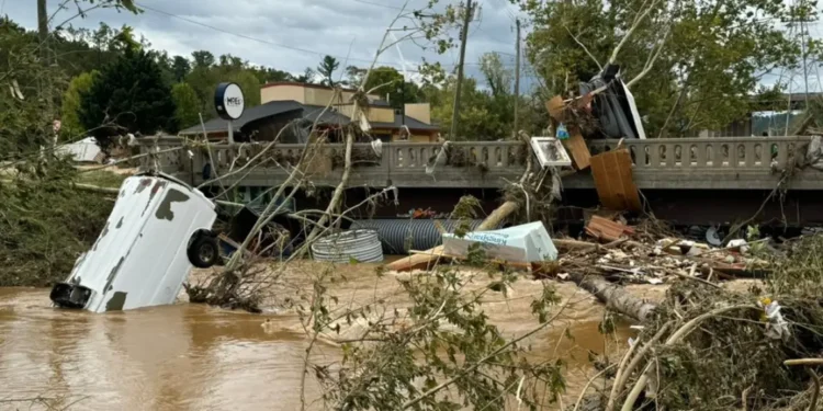 Flooding in Biltmore Village during Hurricane Helene recovery efforts, with streets submerged under water. Photo credit: Dan Whittaker.