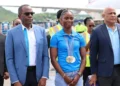 Julien Alfred alongside Prime Minister Philip J. Pierre and Minister Ernest Hilaire at a special ceremony recognizing her Olympic triumph.
