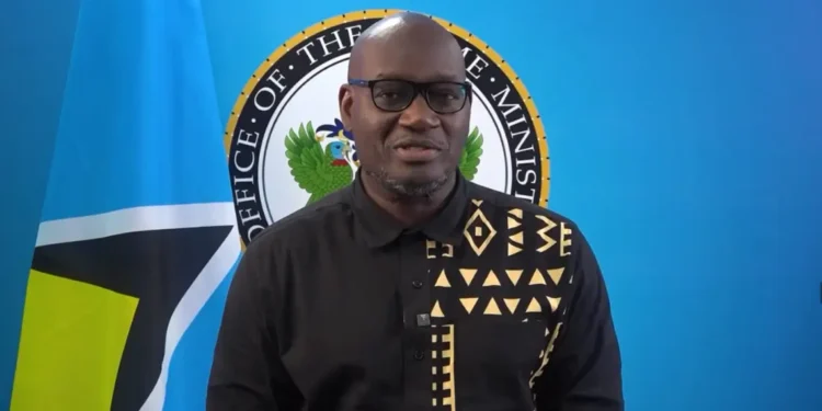 Moses Jn Baptiste under fire as he stands in front of the Office of the Prime Minister seal amid Saint Lucia’s healthcare crisis.