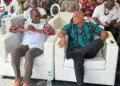 Philip J Pierre and Ernest Hilaire seated side by side at a carnival event amidst the ongoing As the Saint Lucia CIP passport scandal deepens