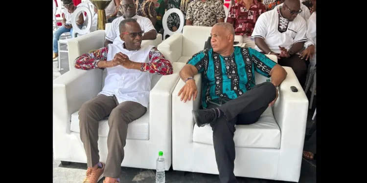 Philip J Pierre and Ernest Hilaire seated side by side at a carnival event amidst the ongoing As the Saint Lucia CIP passport scandal deepens