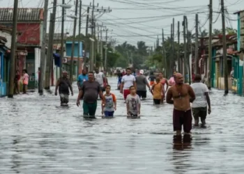 Residents wade through flooded streets as Tropical Storm Helene weakens after passing, causing severe flooding in Batabano, Cuba. (AP Photo/Ramon Espinosa)