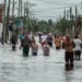 Residents wade through flooded streets as Tropical Storm Helene weakens after passing, causing severe flooding in Batabano, Cuba. (AP Photo/Ramon Espinosa)