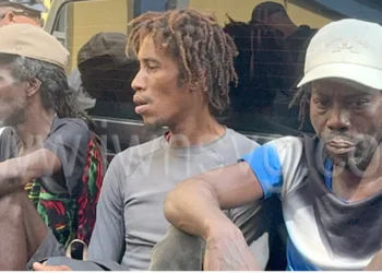 Three Saint Lucians denied bail in cocaine bust sitting in the back of a police pickup in Saint Vincent after being charged with trafficking 22 kilograms of cocaine.