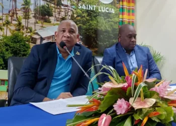 Louis Lewis appointed CEO of Saint Lucia Tourism Authority alongside Ernest Hilaire at the head table during the appointment ceremony.