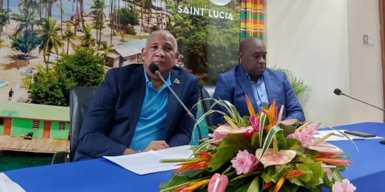 Louis Lewis appointed CEO of Saint Lucia Tourism Authority alongside Ernest Hilaire at the head table during the appointment ceremony.