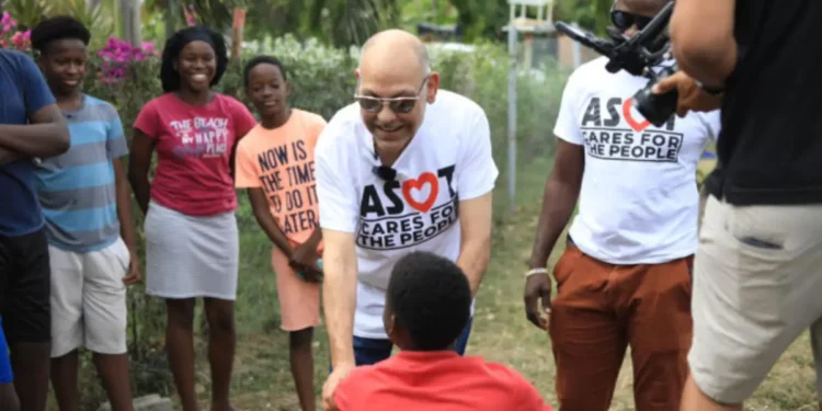Asot Michael, known for his community outreach, pictured meeting and greeting children before his tragic death. Asot Michael death has shocked the nation.