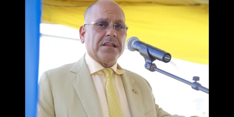 Asot Michael speaking at a podium during a public event, representing Antigua in mourning following his tragic passing