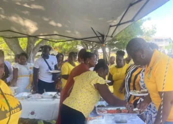 Community members in St Lucia gather under a tent for the UWP's 16 Days of Activism St Lucia campaign to address gender-based violence.