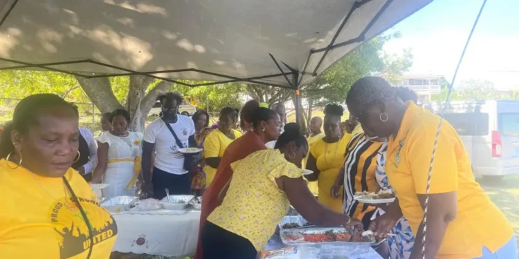 Community members in St Lucia gather under a tent for the UWP's 16 Days of Activism St Lucia campaign to address gender-based violence.