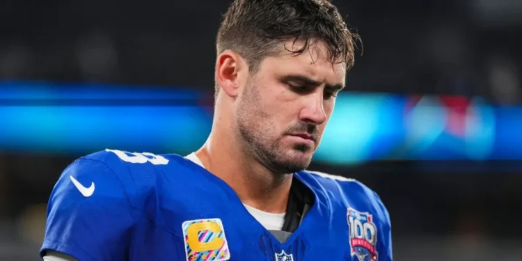Daniel Jones NFL Contract Release - Daniel Jones, former Giants quarterback, reflects on the sidelines after his NFL contract release announcement.