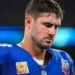 Daniel Jones NFL Contract Release - Daniel Jones, former Giants quarterback, reflects on the sidelines after his NFL contract release announcement.