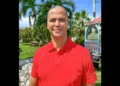 Ellio Solomon in red shirt appointed as cruise tourism advocate Cayman Islands, leading ACT’s public education efforts