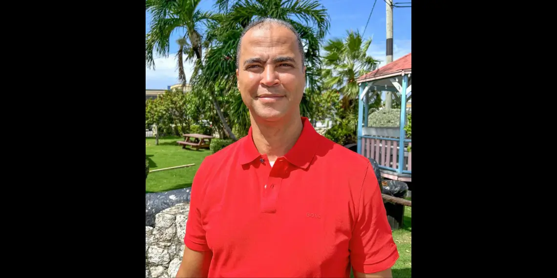 Ellio Solomon in red shirt appointed as cruise tourism advocate Cayman Islands, leading ACT’s public education efforts