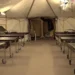 Interior view of Saint Lucia field hospital abandoned by SLP government, showing rows of empty hospital beds in unused medical facility.
