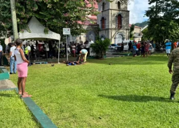 Scene of the fatal Castries shooting at Derek Walcott Square, showing bystanders, law enforcement, and the investigation area.