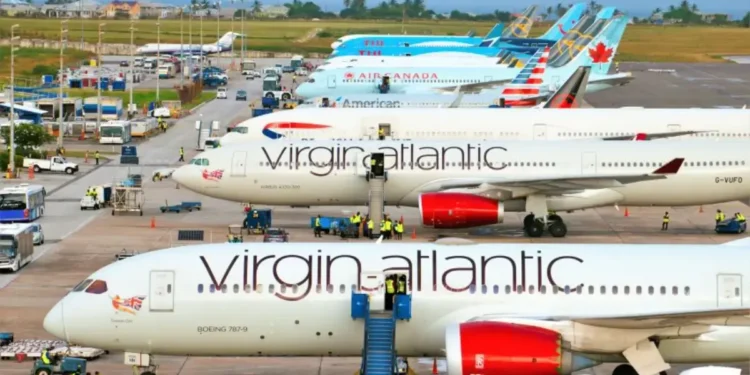 Airplanes on the tarmac during the Barbados airport milestone at Grantley Adams International Airport.