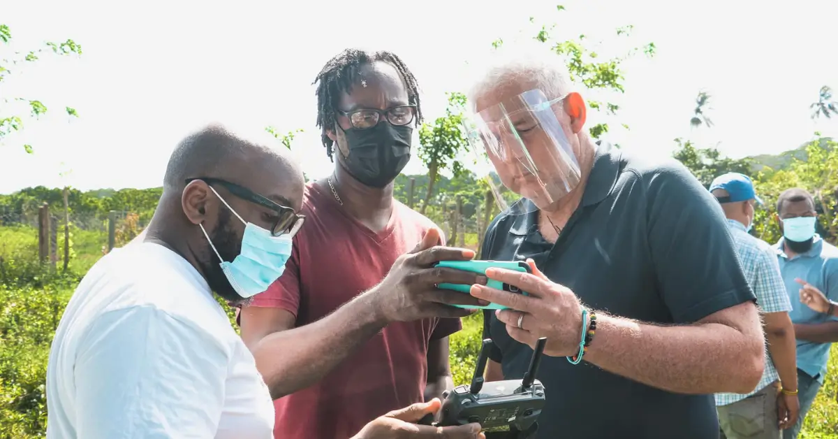 Allen Chastanet in discussion with drag racing enthusiasts at the proposed Dennery site, highlighting proactive solutions as Kenson Casimir exposed for mishandling the Cacabef lease controversy.