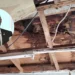 Castries Polyclinic roof leak showing water-damaged plywood with an overlay of Health Minister Moses Jn Baptiste addressing the issue.