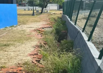 Crumbling Gros Islet park infrastructure with damaged walls and overgrown vegetation, highlighting construction flaws.