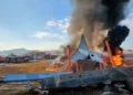 Jeju Air Boeing 737-800 engulfed in flames after the South Korea plane crash at Muan International Airport, with emergency crews on-site.