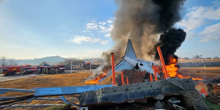 Jeju Air Boeing 737-800 engulfed in flames after the South Korea plane crash at Muan International Airport, with emergency crews on-site.
