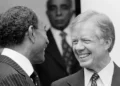Jimmy Carter inspiring legacy shown as he smiles with Anwar Sadat during diplomatic talks.