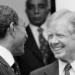 Jimmy Carter inspiring legacy shown as he smiles with Anwar Sadat during diplomatic talks.
