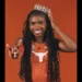 Naomi London in Texas Longhorns uniform, smiling with a crown and hand gesture.