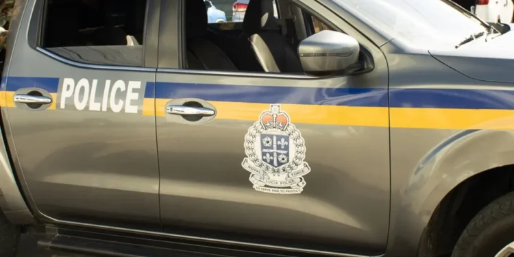 Side view of a Royal Saint Lucia Police Force vehicle, featuring official insignia and markings, actively used in the Vincentian National Shooting investigation on Water Works Road.
