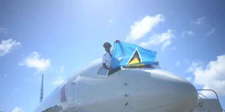 St Lucian pilot Tevin Belasco proudly waves the national flag upon landing, symbolizing achievement amidst St Lucia Left Behind.