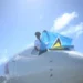 St Lucian pilot Tevin Belasco proudly waves the national flag upon landing, symbolizing achievement amidst St Lucia Left Behind.