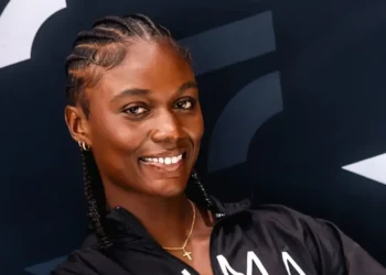 The Julien Alfred Story A portrait of Julien Alfred smiling confidently, symbolizing her historic journey as St Lucia’s first Olympic gold medalist