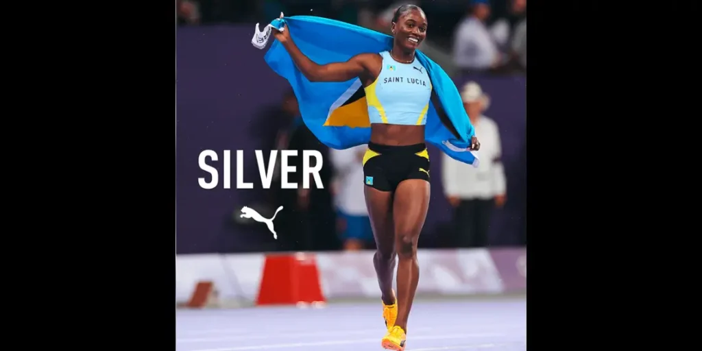 The Julien Alfred Story Julien Alfred celebrates with the St Lucian flag after a stellar performance, symbolizing her historic achievements