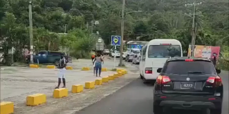 Traffic builds along the scene of a fatal accident in Dennery, where one person has been confirmed dead following a truck collision.