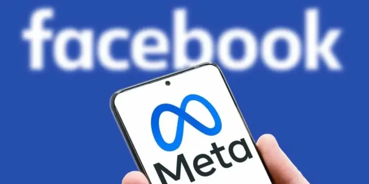 A smartphone displaying the Meta logo with a blurred Facebook logo in the background, symbolizing the Meta policy shift toward free expression and community-driven moderation.