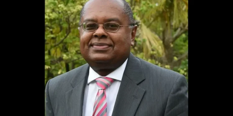Dr. James Fletcher, a distinguished St. Lucian climate advocate and CARICOM Climate Envoy, pictured in a formal suit outdoors.