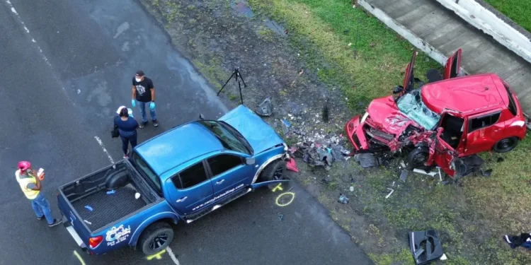 Fatal Gros Islet Highway collision showing a damaged red Suzuki Swift and blue Mitsubishi Sportero as investigators examine the scene.