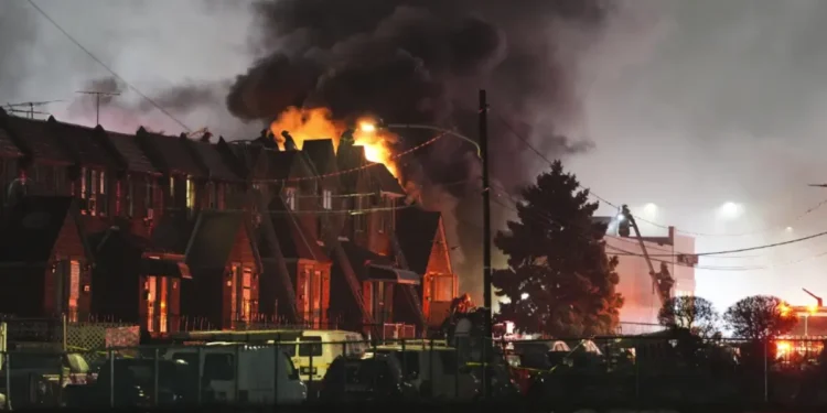 First responders at the scene of the deadly Philadelphia plane crash, where a Learjet crash ignited a fireball, engulfing homes in flames. (Credit AP)