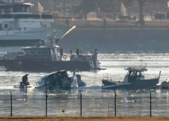 First responders recover debris from American Airlines crash near Reagan Airport.
