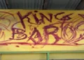 Graffiti reading King Baros defacing a bus shelter in Belle Vue, highlighting the Belle Vue vandalism incident addressed by the RSLPF crackdown.