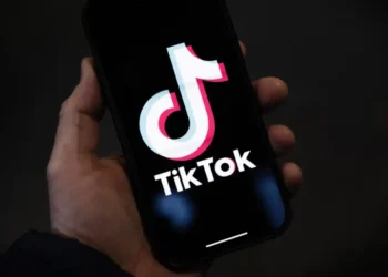 Hand holding a smartphone displaying the TikTok logo, as TikTok shutdown looms over security concerns and legal debates.
