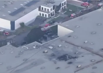 Scene of the California plane crash in Fullerton showing damaged building and responders