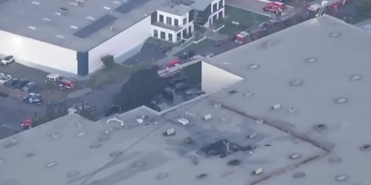 Scene of the California plane crash in Fullerton showing damaged building and responders
