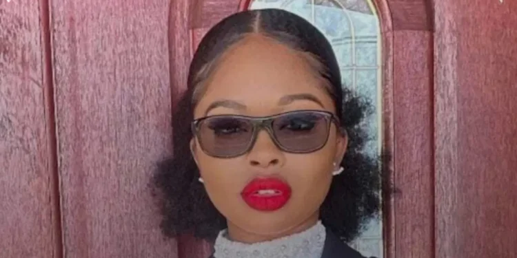 Shantrese Dorsett, St Kitts Nevis Crown Counsel charged in a high-profile murder case, poses in professional attire in front of a wooden door.