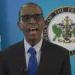St Lucia PM Philip Pierre speaking in front of the Office of the Prime Minister emblem and Saint Lucia flag