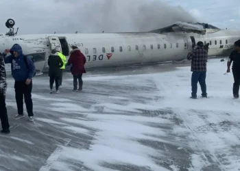 A Delta flight overturned on a snowy runway at Toronto Pearson, with emergency crews responding amid harsh winter conditions.
