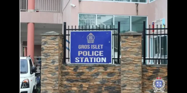Gros Islet Police Station entrance with a blue sign and security fencing. St Lucia Police investigate missing M16 rifle from this facility.