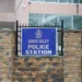 Gros Islet Police Station entrance with a blue sign and security fencing. St Lucia Police investigate missing M16 rifle from this facility.